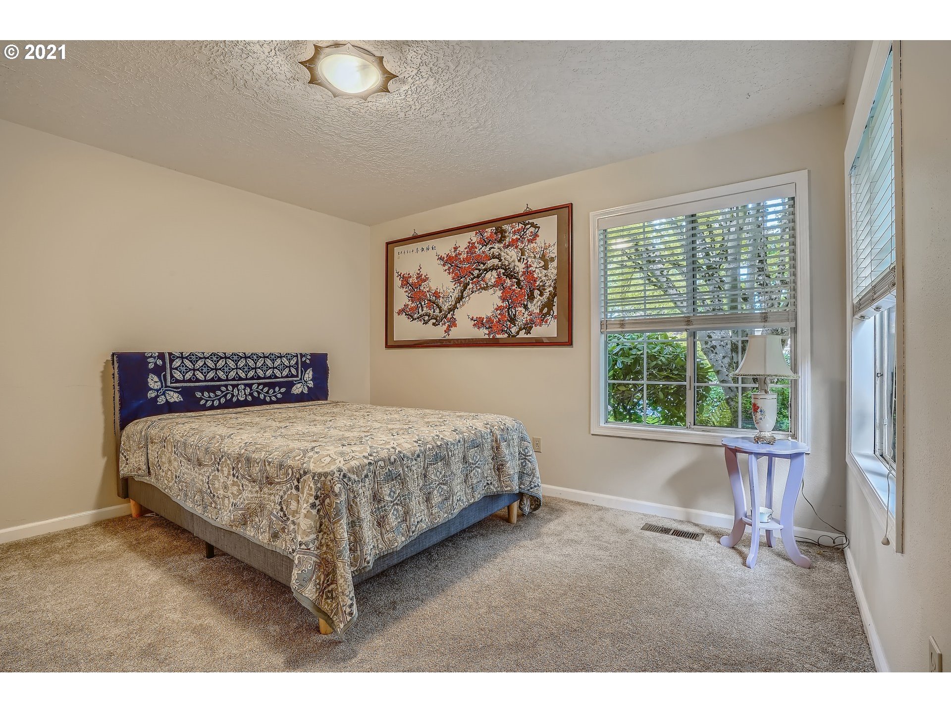 545 Southwest 167th Avenue Beaverton, OR 97006 - Photo 19 of 32 a bed sitting in a bedroom next to a window