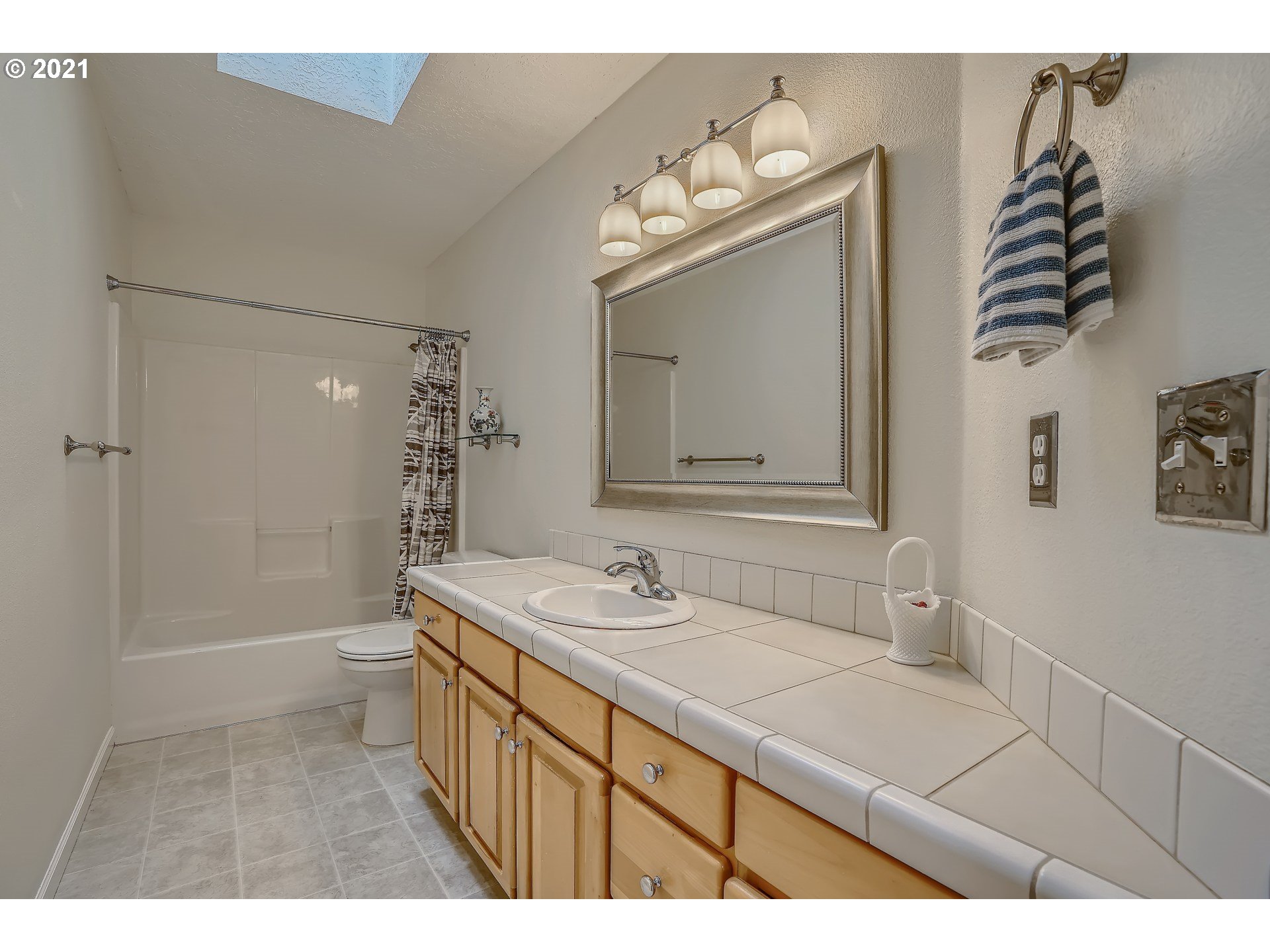 545 Southwest 167th Avenue Beaverton, OR 97006 - Photo 20 of 32 a bathroom with a sink a toilet and shower