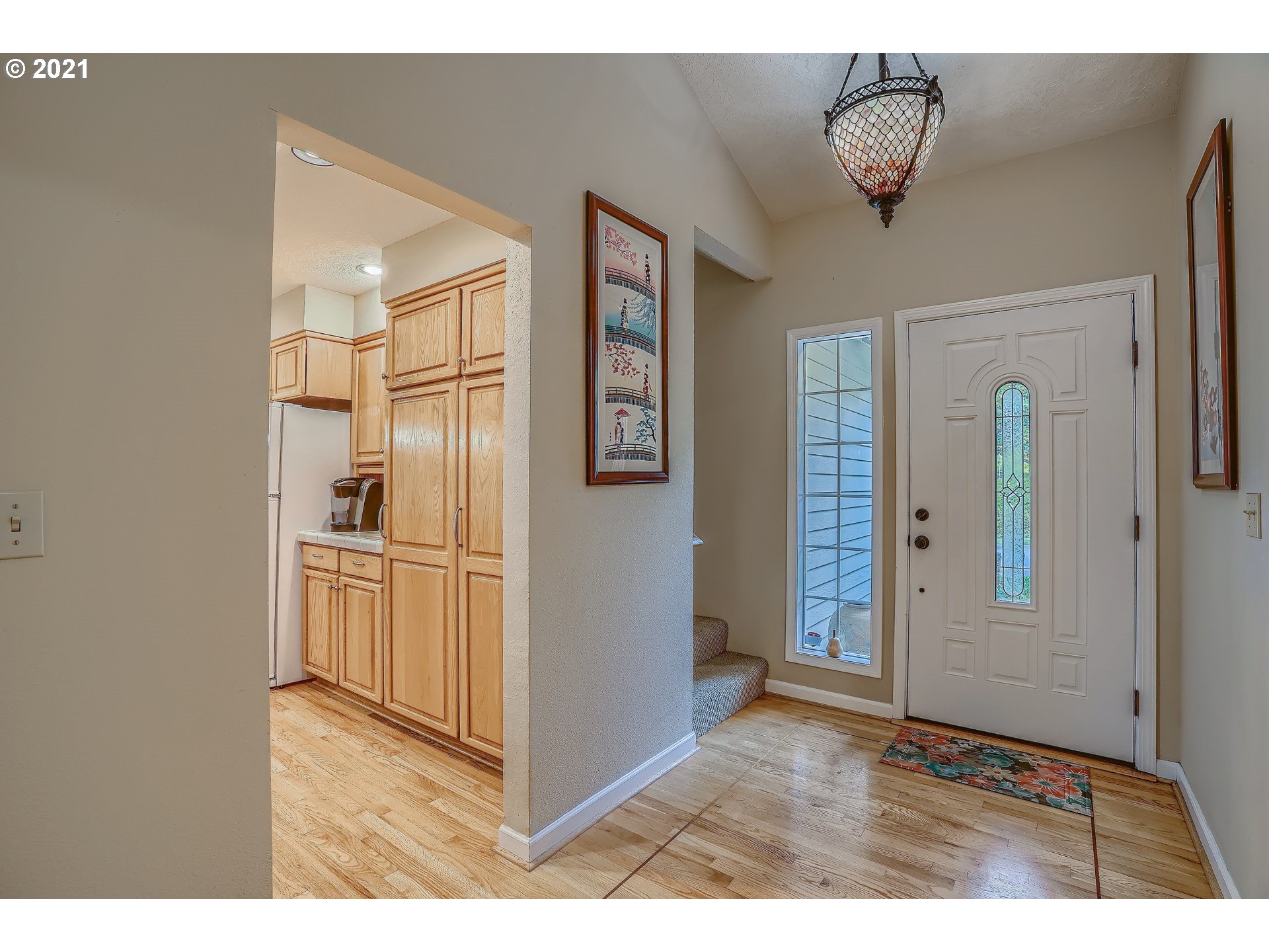 545 Southwest 167th Avenue Beaverton, OR 97006 - Photo 3 of 32 a view of a hallway with wooden floor and chandelier