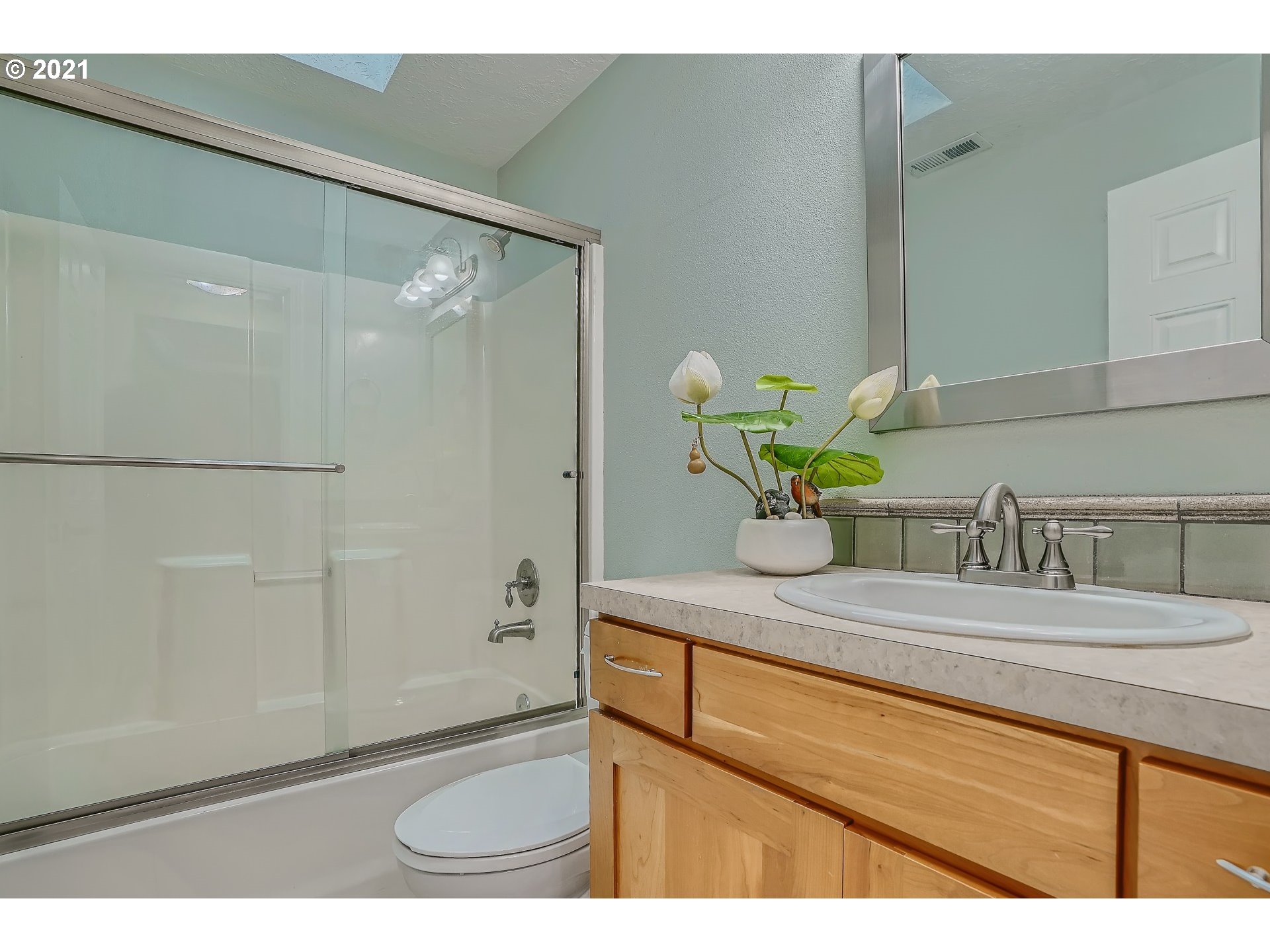 545 Southwest 167th Avenue Beaverton, OR 97006 - Photo 22 of 32 a bathroom with a sink a mirror and a shower