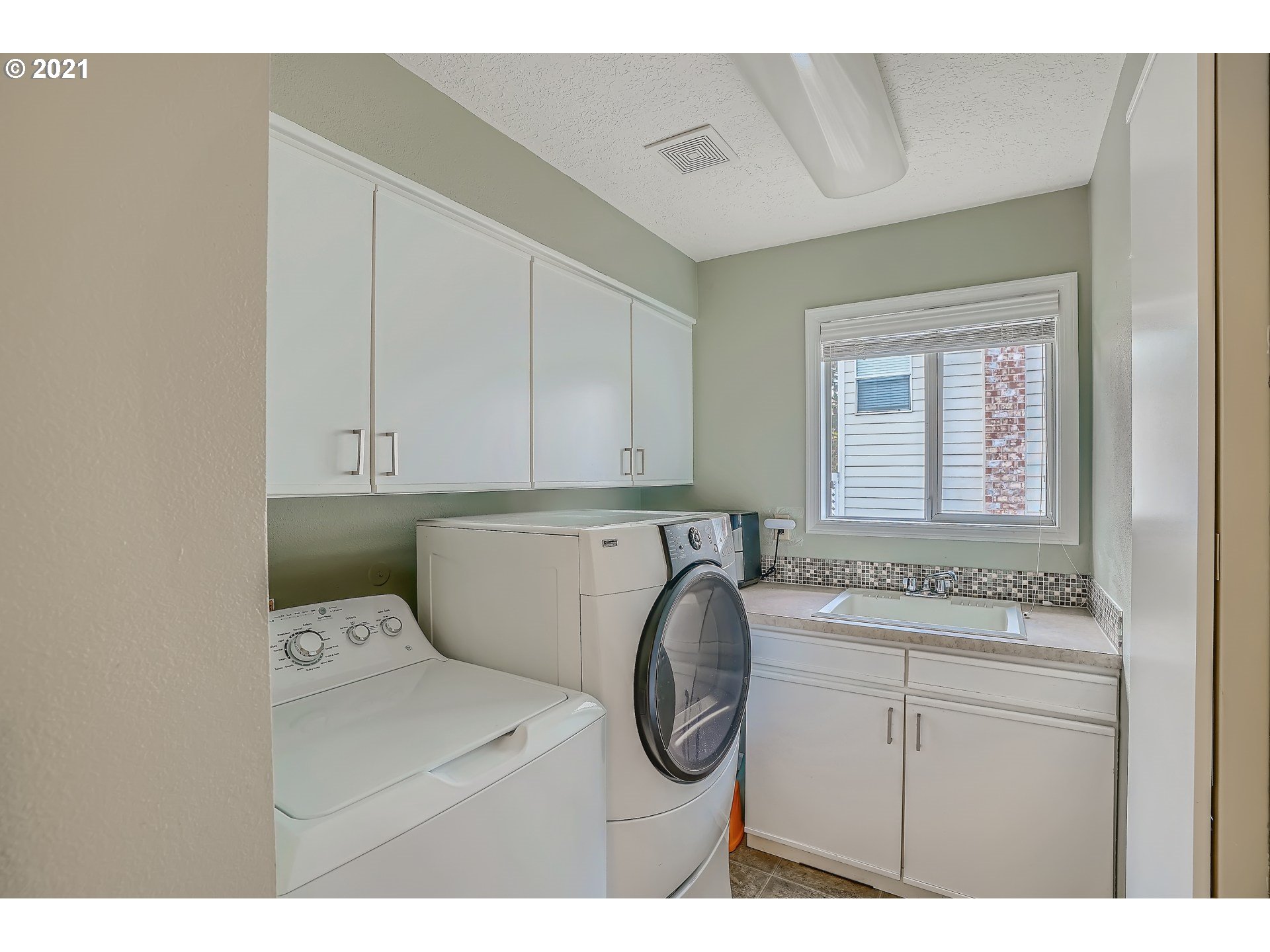 545 Southwest 167th Avenue Beaverton, OR 97006 - Photo 25 of 32 a bathroom with a sink and a washing machine
