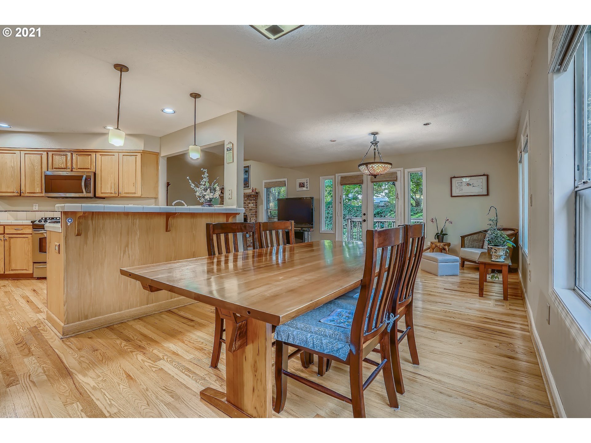545 Southwest 167th Avenue Beaverton, OR 97006 - Photo 9 of 32 a dining room with furniture a chandelier and wooden floor