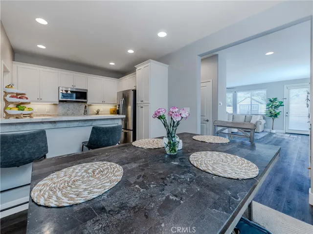 a kitchen with microwave and dining table
