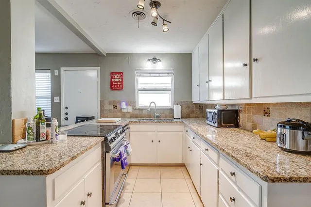 a kitchen with a sink stove and cabinets