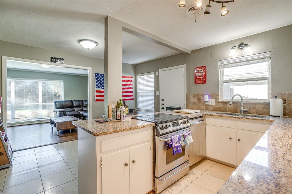 3612 Winston Road Fort Worth, TX 76109 - Photo 17 of 40 a kitchen with stainless steel appliances granite countertop a stove and a sink