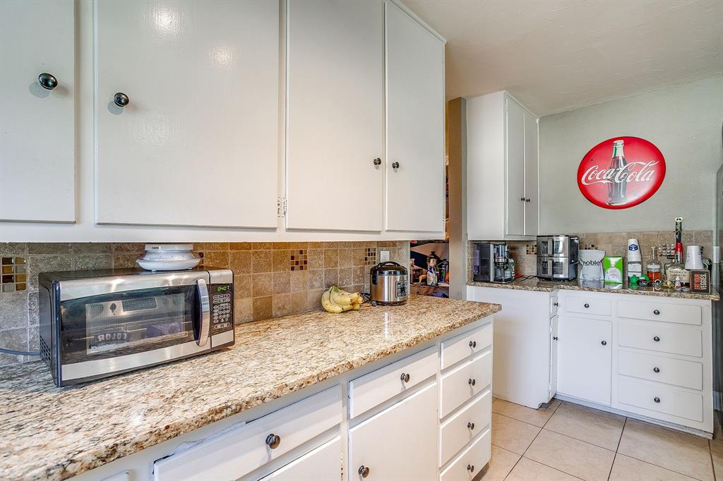3612 Winston Road Fort Worth, TX 76109 - Photo 19 of 40 a kitchen with granite countertop a stove a sink and a counter space