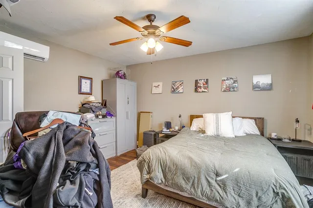 a bedroom with a bed and a ceiling fan