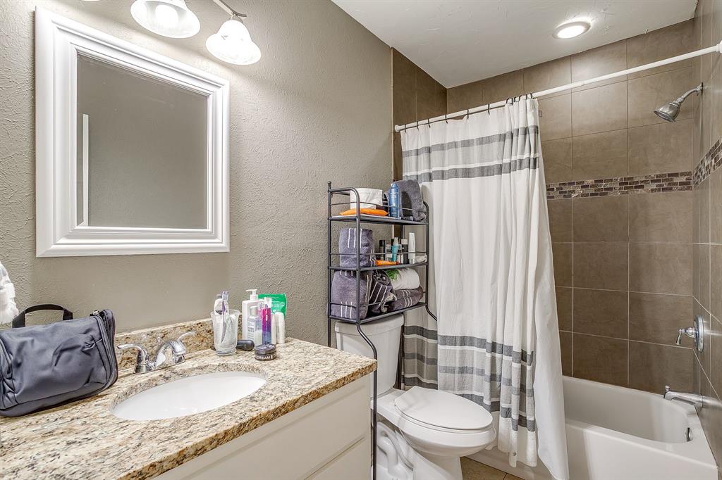 3612 Winston Road Fort Worth, TX 76109 - Photo 22 of 40 a bathroom with a granite countertop sink toilet and shower