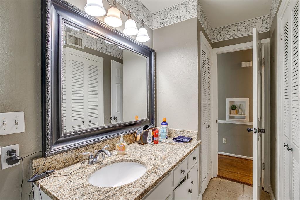 3612 Winston Road Fort Worth, TX 76109 - Photo 23 of 40 a bathroom with a granite countertop sink and a mirror