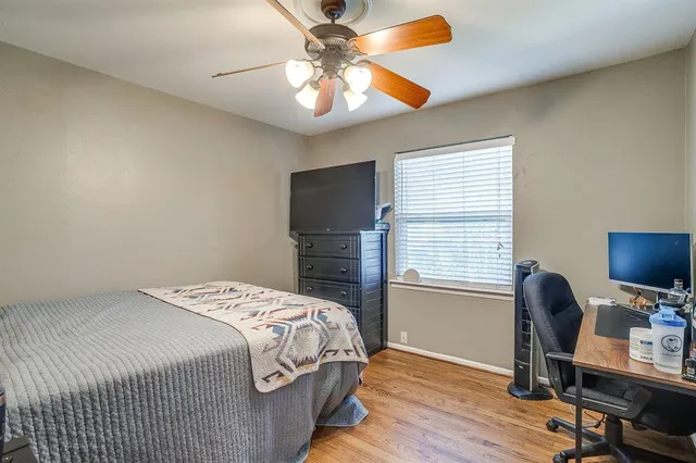 a bedroom with a bed and a desk