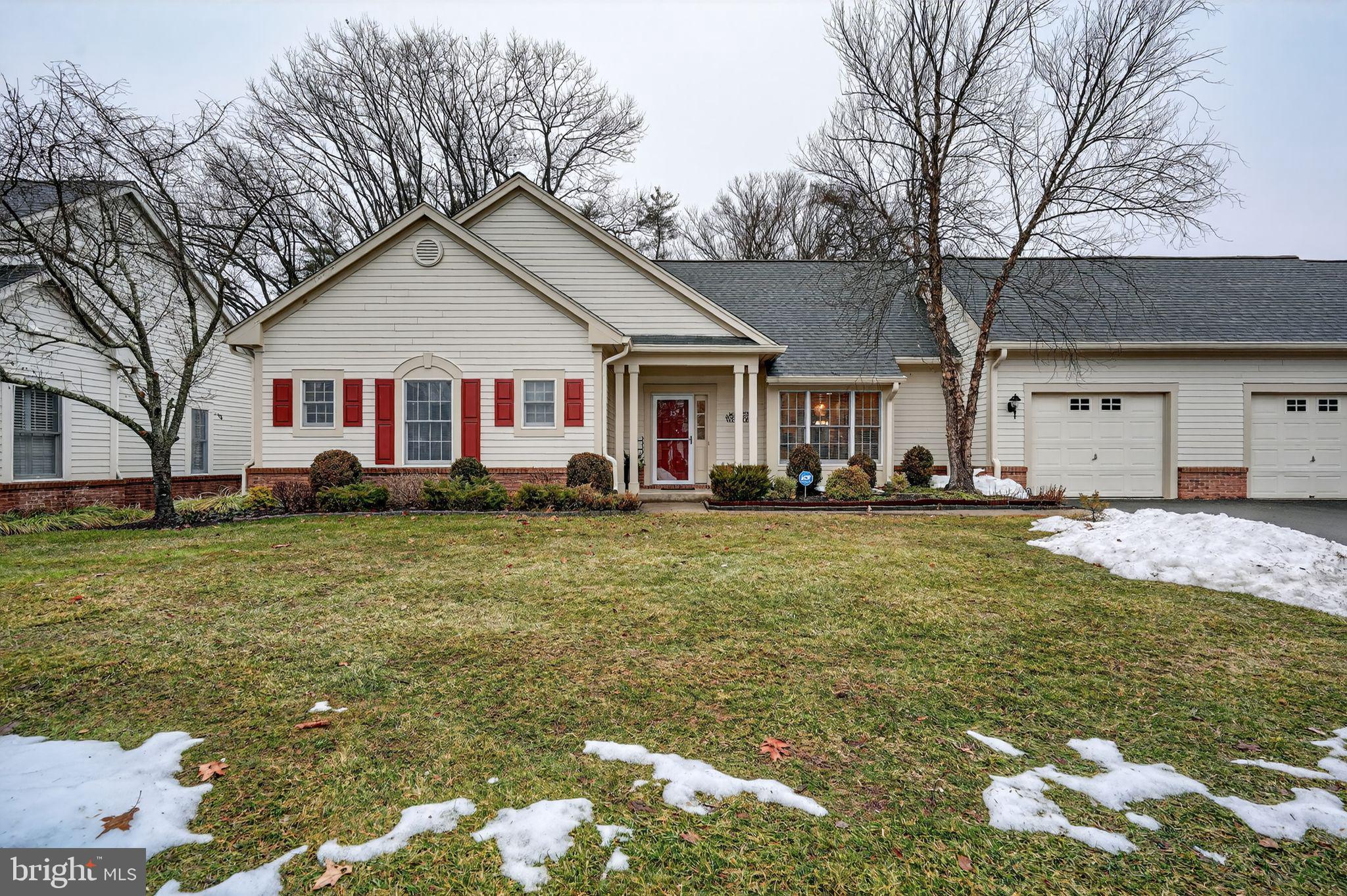 a front view of house with yard and trees around