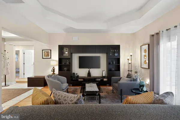 a living room with furniture and wooden floor