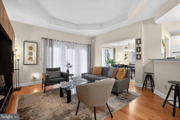 a living room with furniture and a view of kitchen