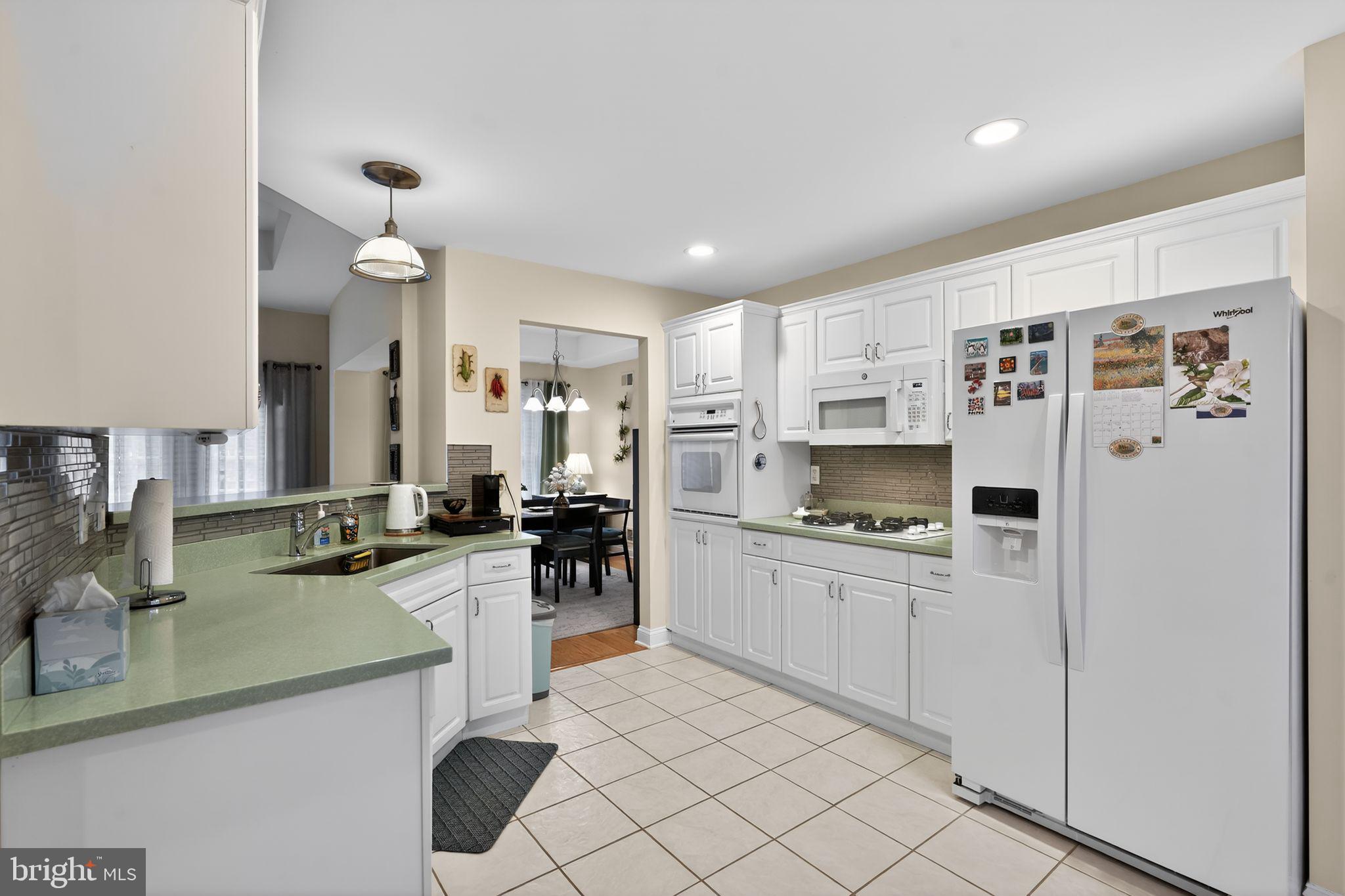 13 Hedge Row Road Princeton, NJ 08540 - Photo 20 of 41 a kitchen with granite countertop cabinets and refrigerator