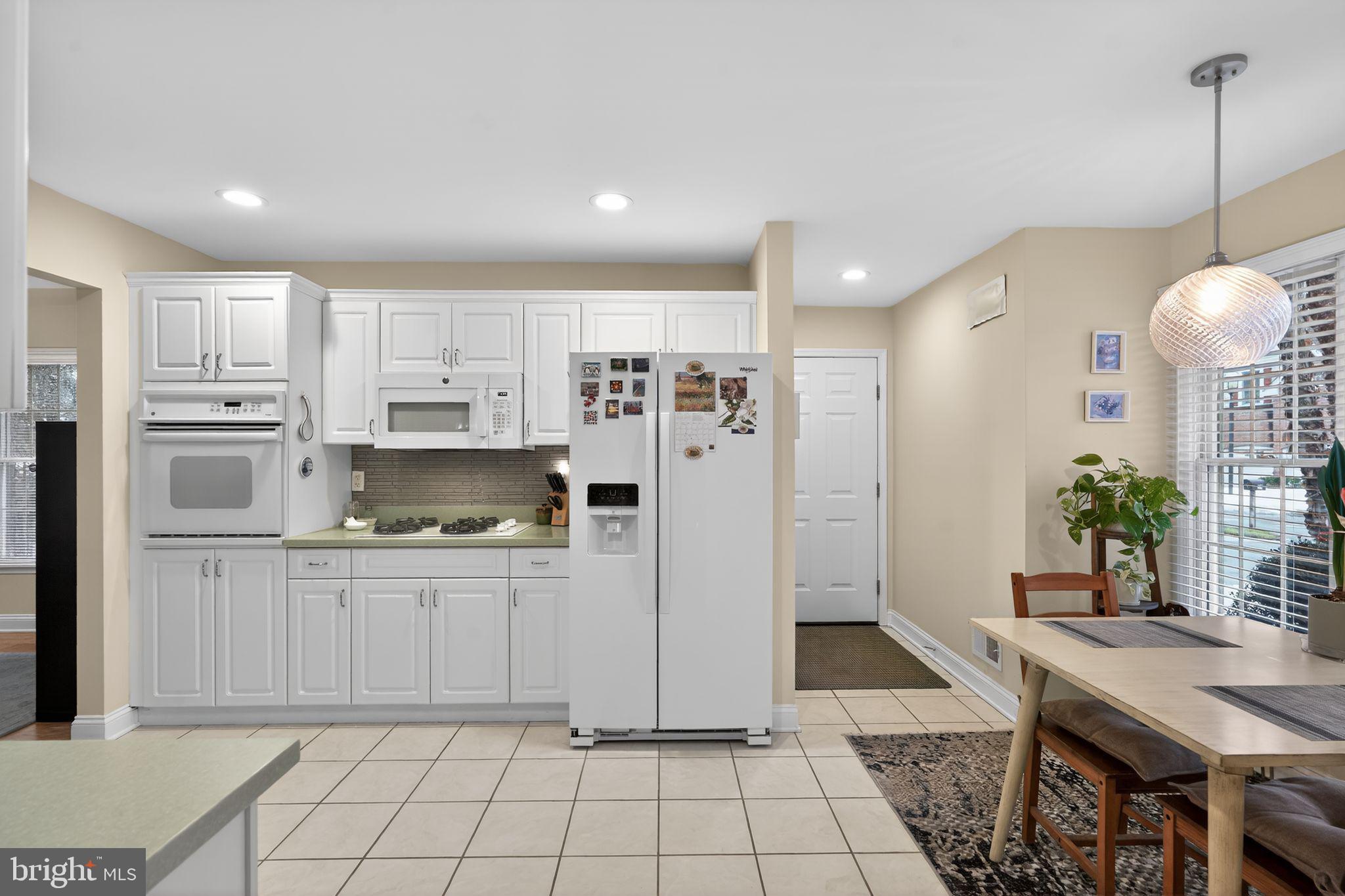 13 Hedge Row Road Princeton, NJ 08540 - Photo 21 of 41 a kitchen with kitchen island white cabinets and refrigerator