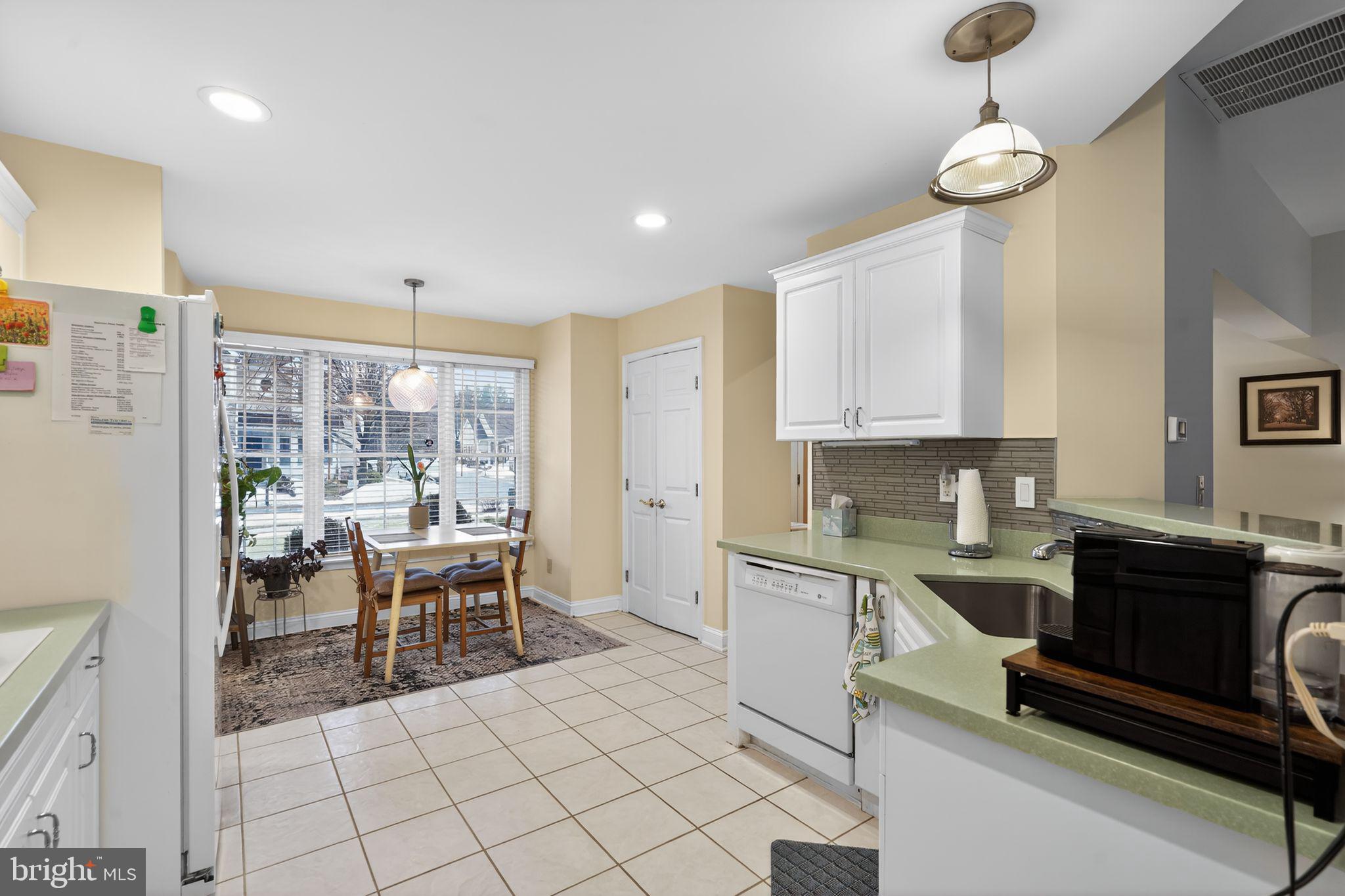 13 Hedge Row Road Princeton, NJ 08540 - Photo 23 of 41 a kitchen with a dining table chairs and white cabinets