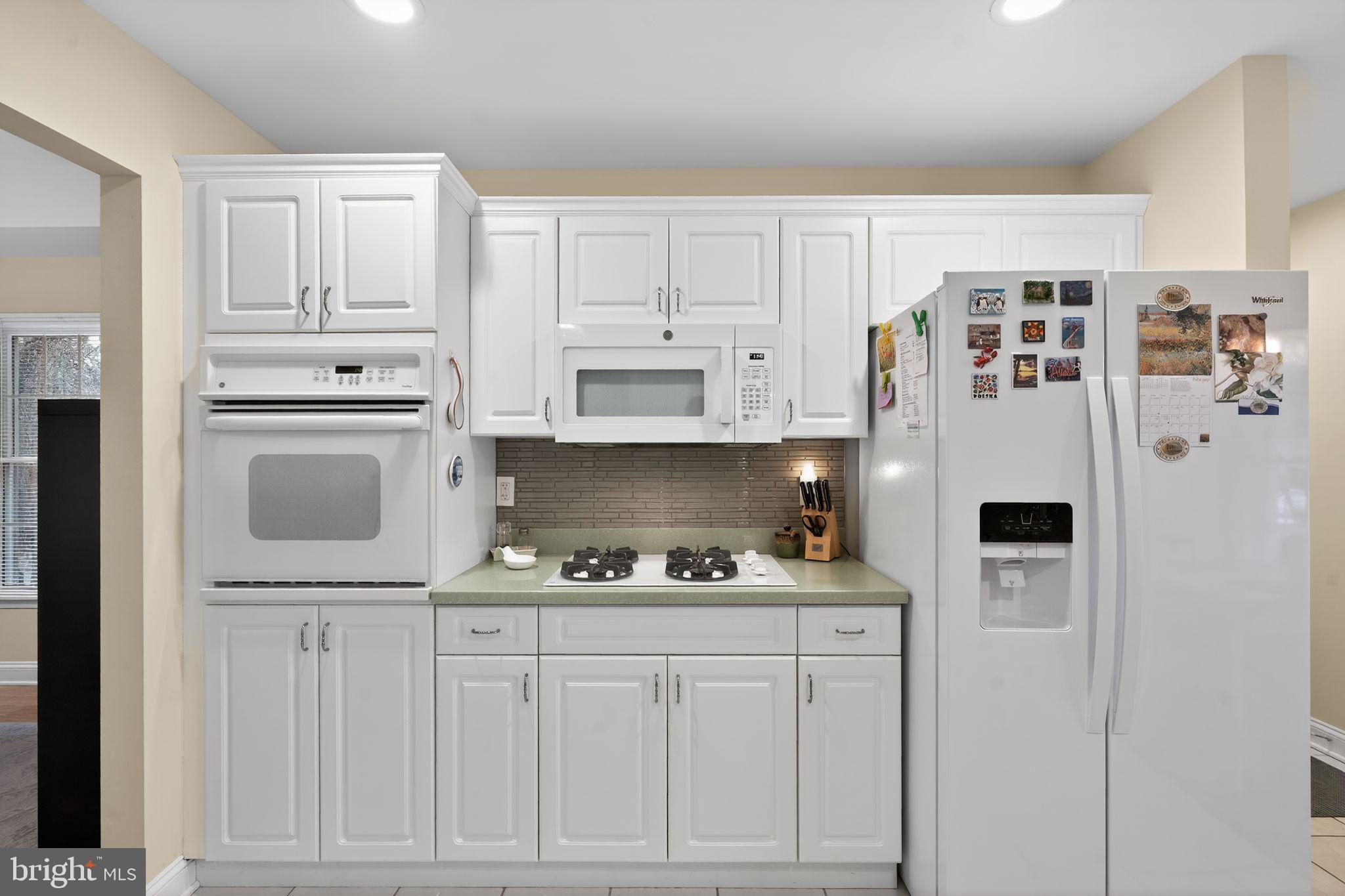 13 Hedge Row Road Princeton, NJ 08540 - Photo 24 of 41 a kitchen with white cabinets and refrigerator