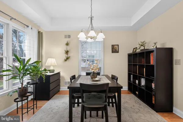 a dining room with furniture and a window