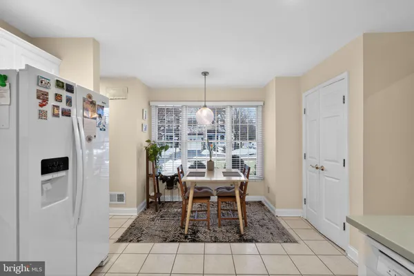a dining room with furniture a chandelier and window