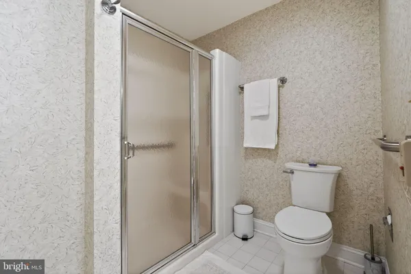 a spacious bathroom with a double vanity sink a mirror and a toilet
