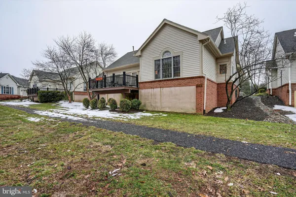 a view of a house with a yard covered in snow