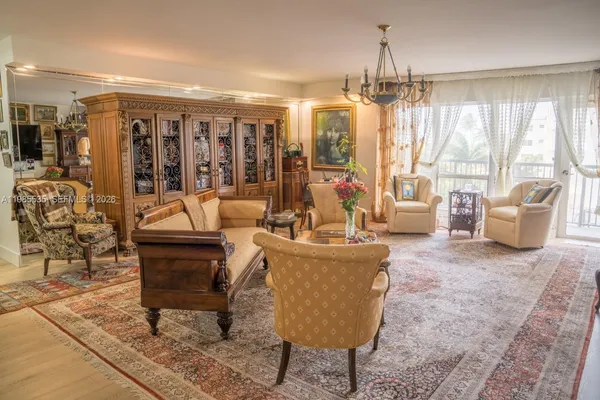 a living room with furniture and a chandelier