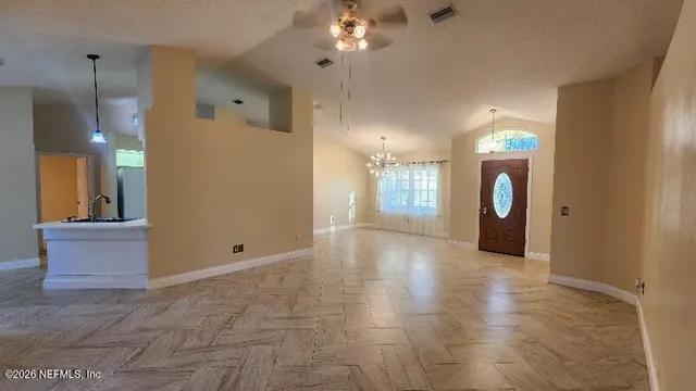 a view of a hallway with a chandelier