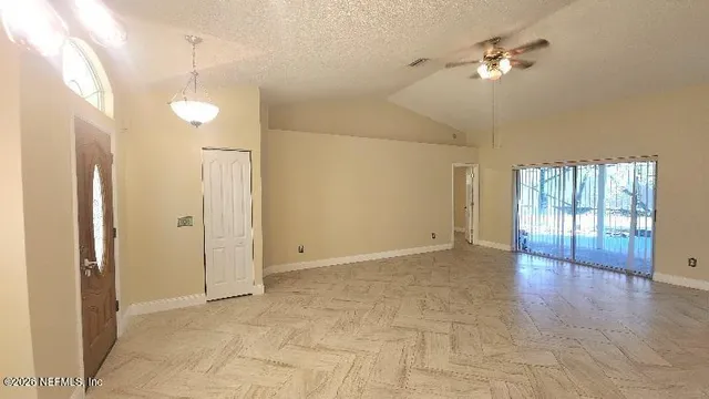 a view of an empty room with a window