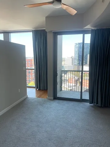 an empty room with large windows