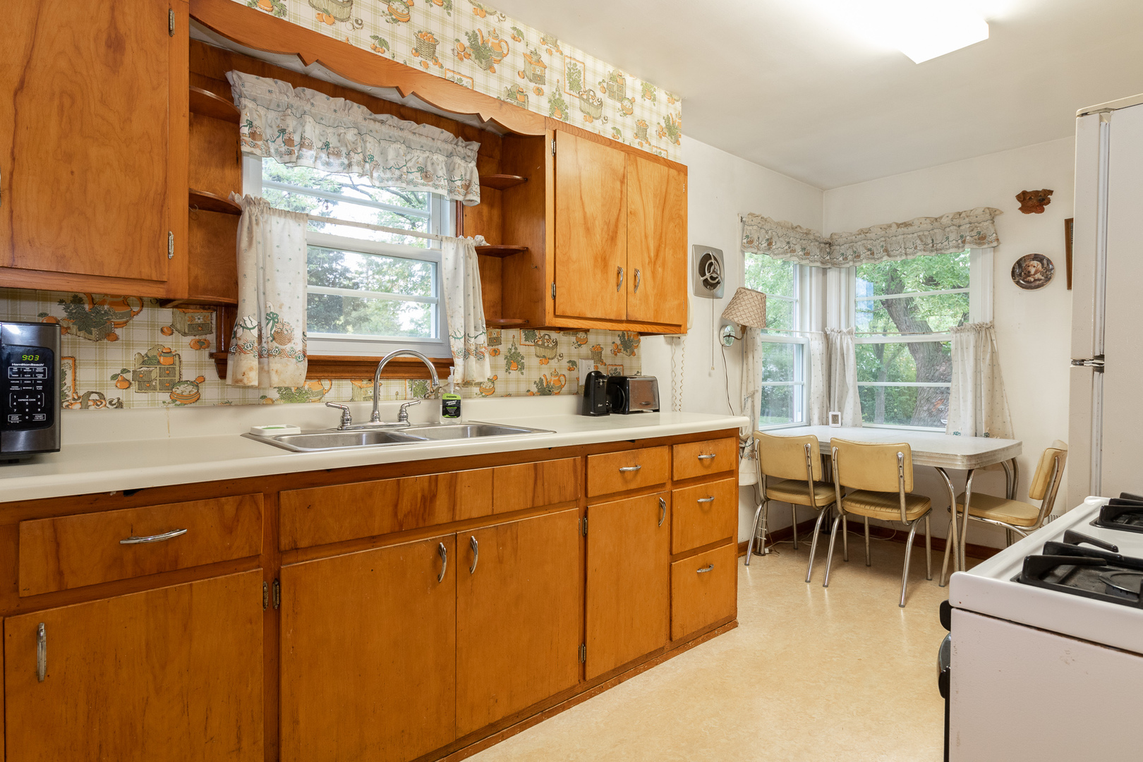 2131 Spruce Road Homewood, IL 60430 - Photo 5 of 14 a kitchen with sink cabinets and wooden floor