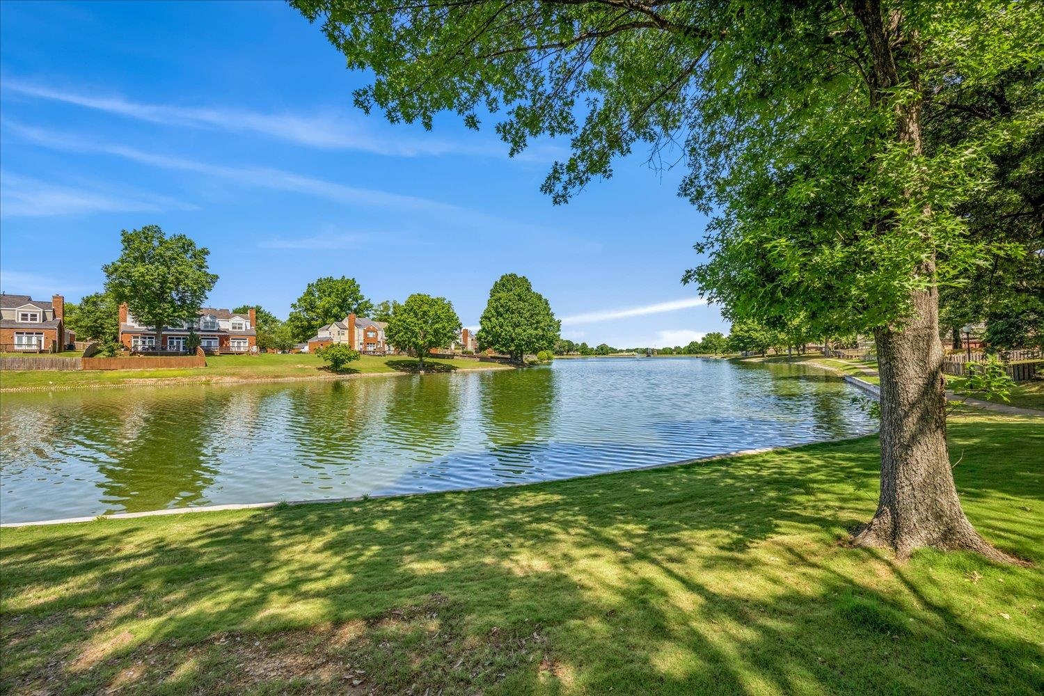 5128 Overview Ridge Memphis, TN 38141 - Photo 27 of 28 Expansive lakefront setting featuring a broad body of water, lush green lawn, and mature trees providing natural shade