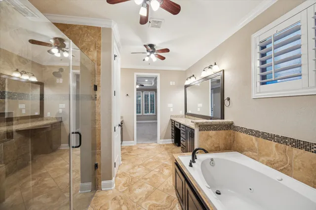 a bathroom with a tub a sink a mirror and a shower