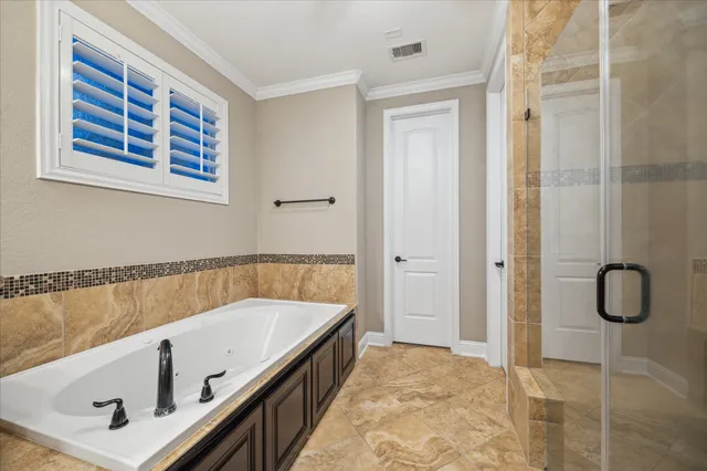 a bathroom with a tub and shower