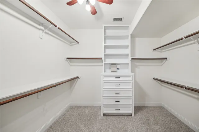 a view of walk in closet with empty racks