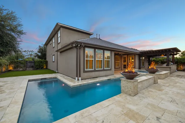 a view of house and outdoor space with swimming pool