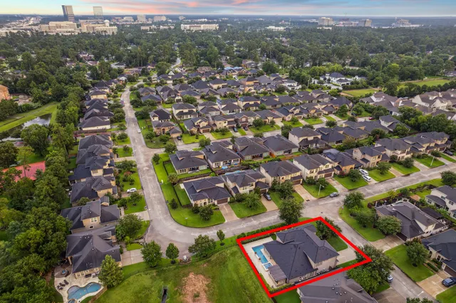 an aerial view of residential building with green space