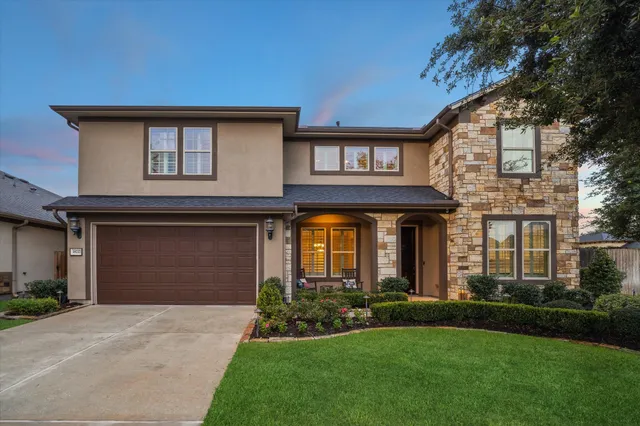 a front view of a house with a yard and garage
