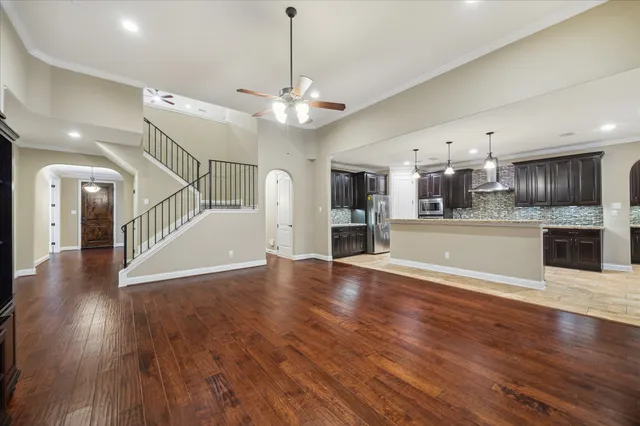 a view of a kitchen with wooden floor and a kitchen
