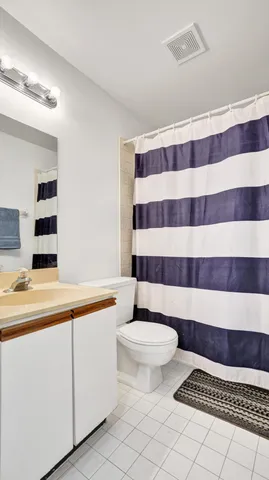 a bathroom with a sink a toilet a mirror and shower