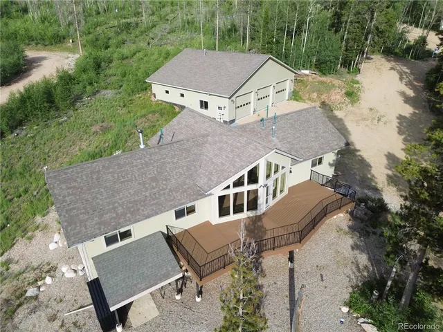 an aerial view of a house with a yard