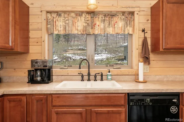 a kitchen with a sink and a window