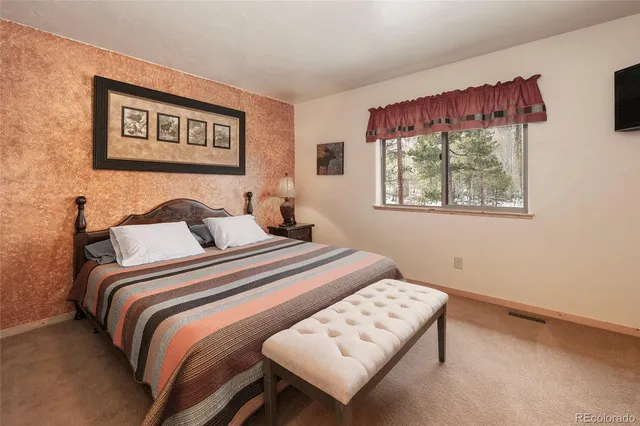 a bedroom with bed and a window