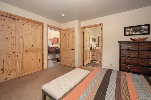 a spacious bedroom with a bed and a dresser