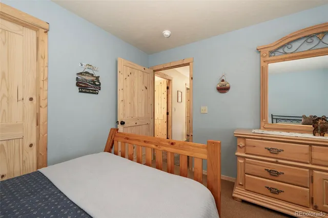 a bedroom with a bed and a mirror