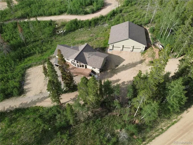 an aerial view of a house with outdoor space and street view