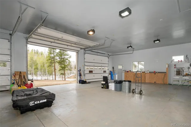 a living room with furniture gym equipment and a large window