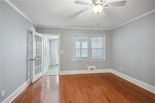 wooden floor in an empty room with a window
