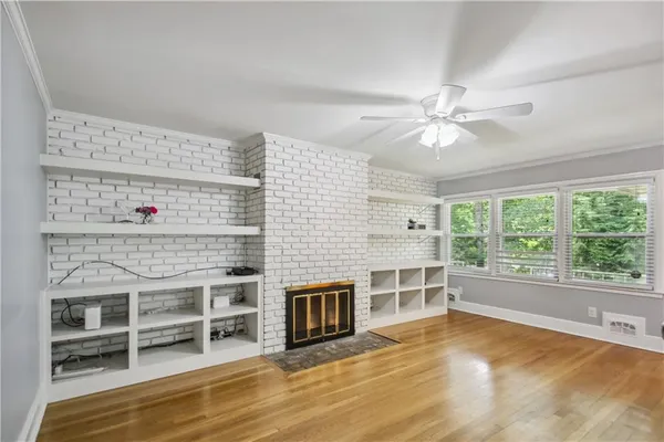 an empty room with a fireplace and windows