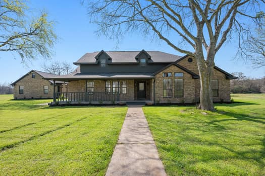 3964 Cliff Road Bryan, TX 77808 - Photo 1 of 1 View of front of house featuring stone siding, a p