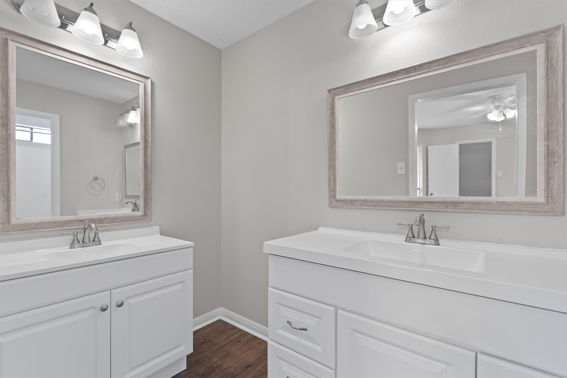 13357 Water Oak Lane, Unit A Austin, TX 78729 - Photo 11 of 26 a bathroom with a sink vanity and a mirror